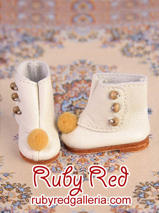 White leather booties with pom pom